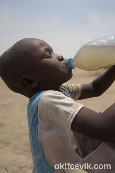 a child drinking water from a bottle