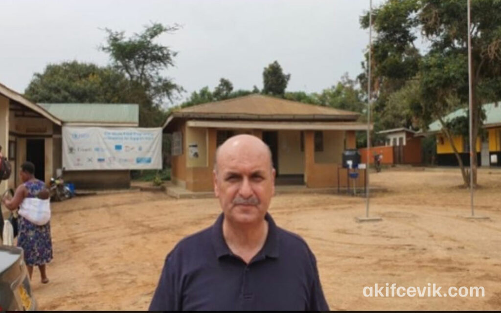 a visitor standing before the information boards at nakivale refugee settlement